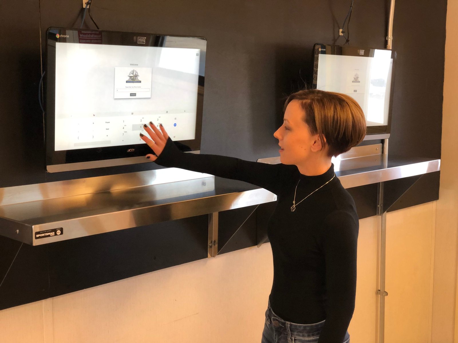 Employee tapping on a touch-screen tablet to complete order fulfillment process