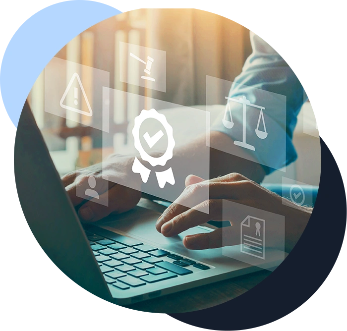 Color image of a professional working at laptop computer on desk while graphic representation of a badge and legal symbols to indicate government regulations