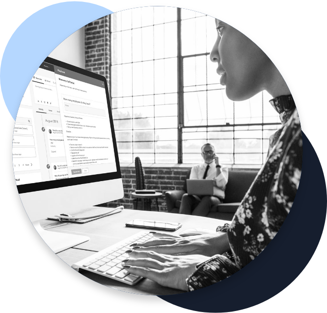 Employee typing on a desktop computer that is pulling information and data from multiple systems into one spot