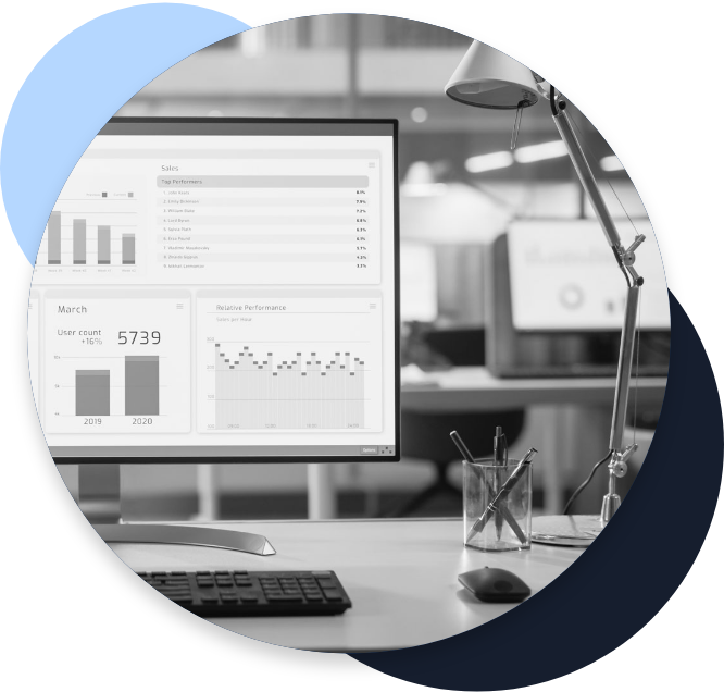 grayscale image of computer on a desk with charts over dark blue and light blue circles
