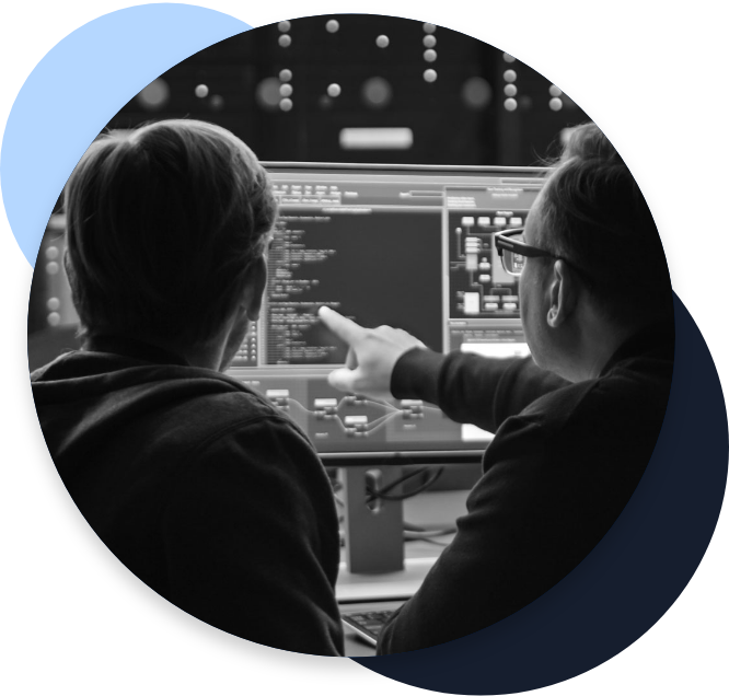 Cybersecurity experts pointing at computer screens displaying code and system information