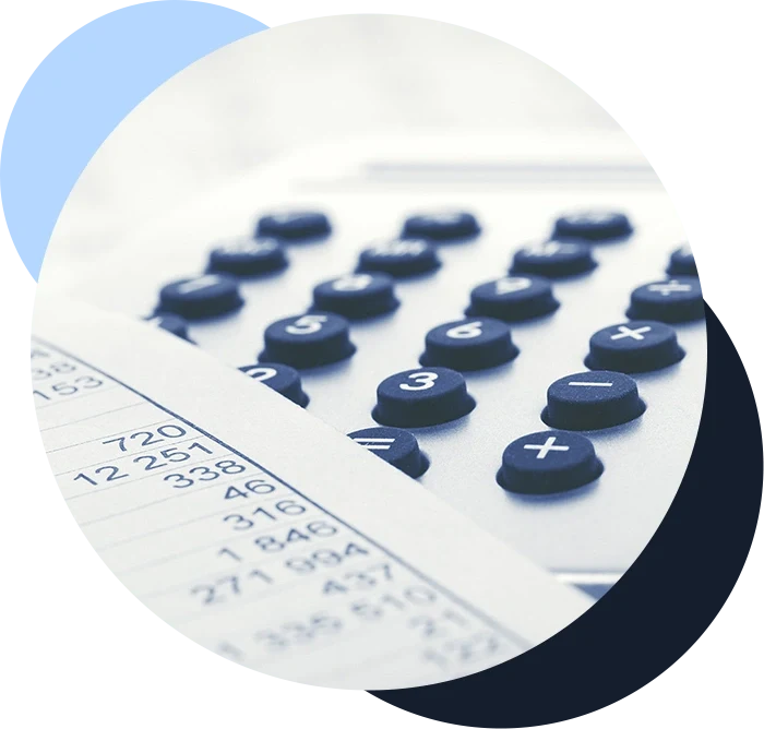 Calculator lying on a desk next to a sheet of paper detailing a business's budget